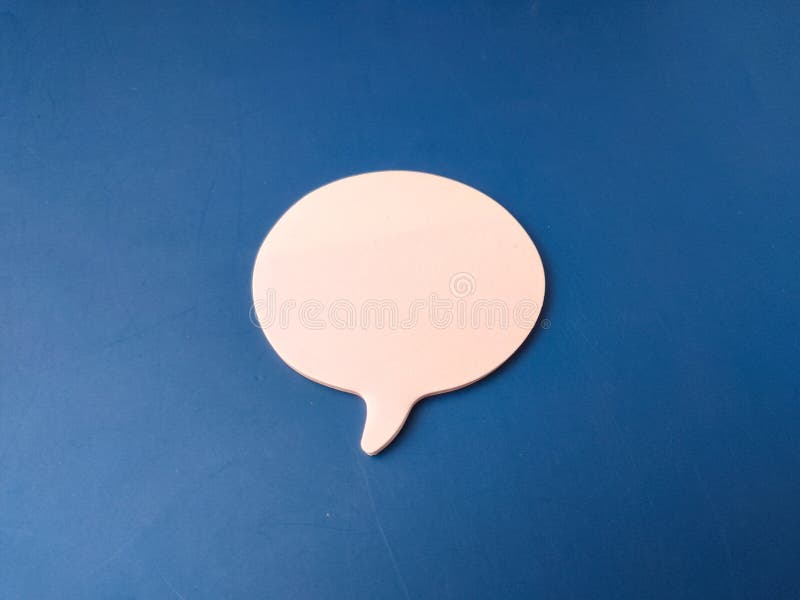 The image features a single, light pink speech or chat bubble set against a solid blue background royalty free stock photos