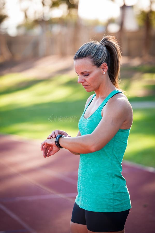 Image of a Female Athlete Adjusting Her Heart Rate Monitor Stock Image - Image of clothing