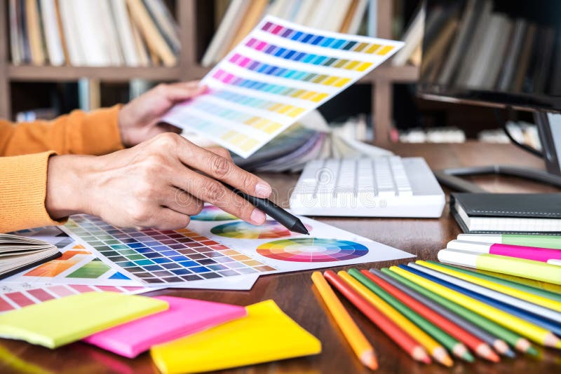 Image of female creative graphic designer working on color selection and drawing on graphics tablet at workplace with work tools royalty free stock photos Image of female creative graphic designer working on color selection and drawing on graphics tablet at workplace with work tools royalty free stock photos