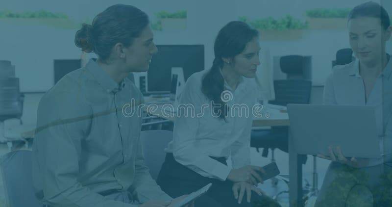 Image of financial data processing over diverse business people using computer in office. Global business, finance, computing and data processing concept digitally generated image.