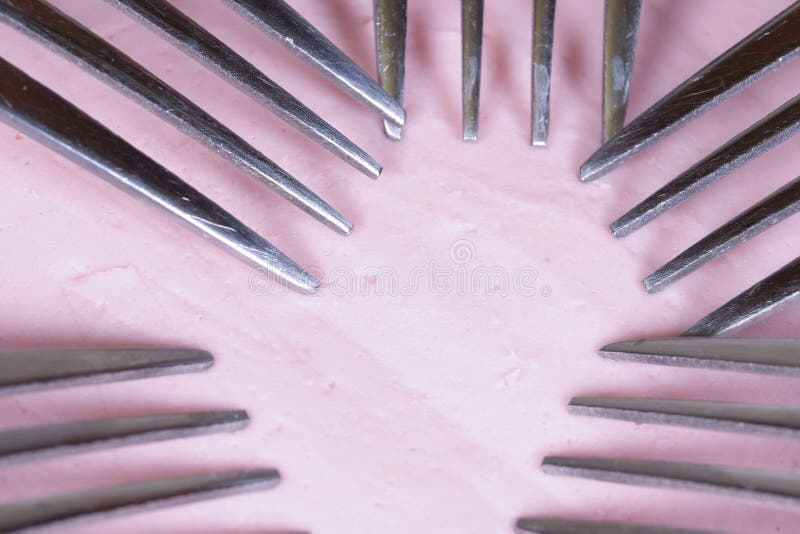 5 forks on a piece of sausage stock image