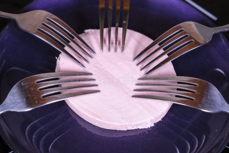 5 forks on a piece of sausage stock photo