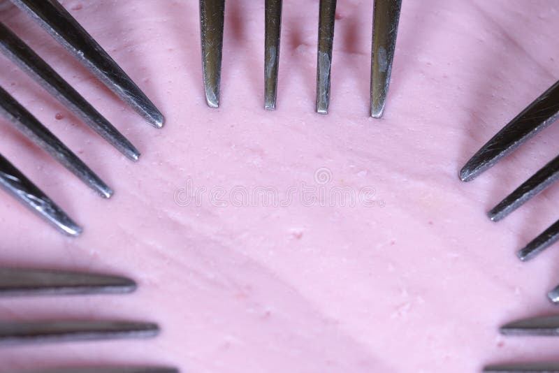 5 forks on a piece of sausage stock photography