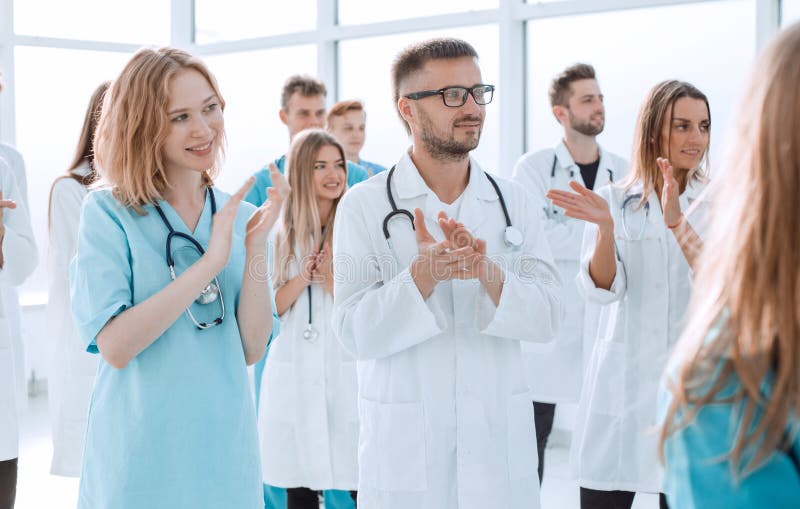 Image of a group of doctors walking in a hospital corridor. stock image