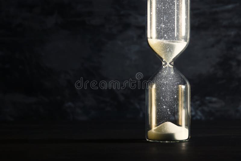 Image of hourglass as time passing concept over black background for business deadline. Glitter overlay.