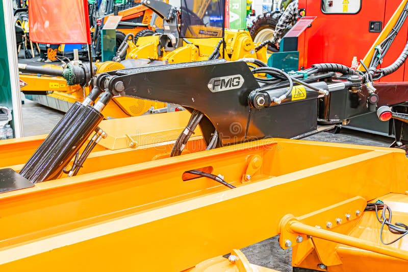 Image of an industrial setting featuring heavy machinery in yellow and black Central focus on a complex machine with control panel stock image