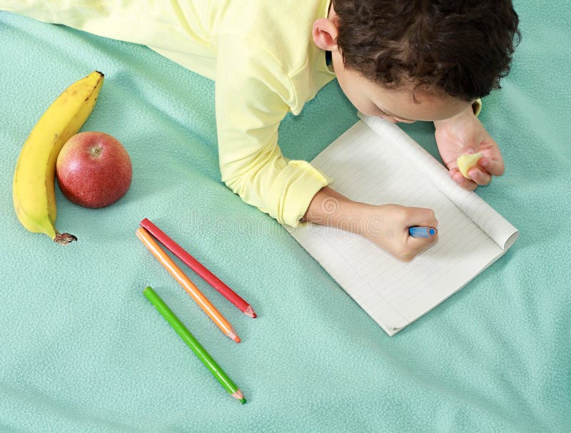 Little boy drawing in his note pad with his coloring pens stock images Little boy drawing in his note pad with his coloring pens stock images