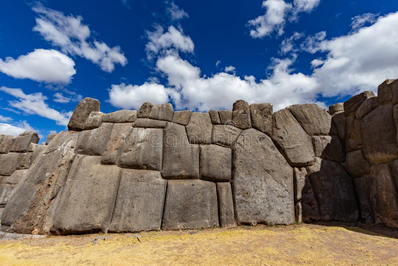 Image of llamas on a stone wall of Sacsayhuaman. Cusco, Peru