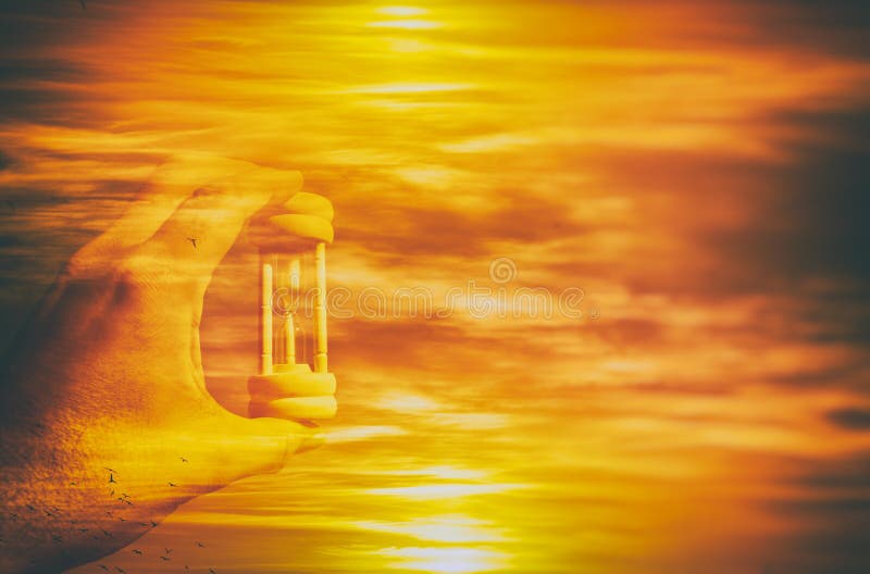 Image of male hand holding hourglass against sky. global warming and ecological problems. double exposure. stock photos Image of male hand holding hourglass against sky. global warming and ecological problems. double exposure. stock photos