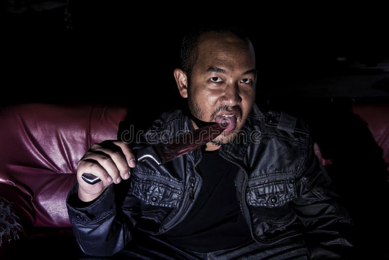 The image of a man holding a scary bloody knife stock image The image of a man holding a scary bloody knife stock image