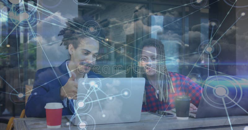 Image of network of connections with icons over men using laptop stock photos