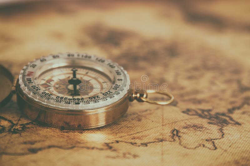 image of old compass over vintage map. selective focus.