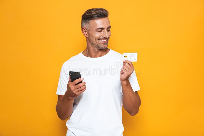 Image of Positive Guy 30s in White T-shirt Holding Mobile Phone and ...