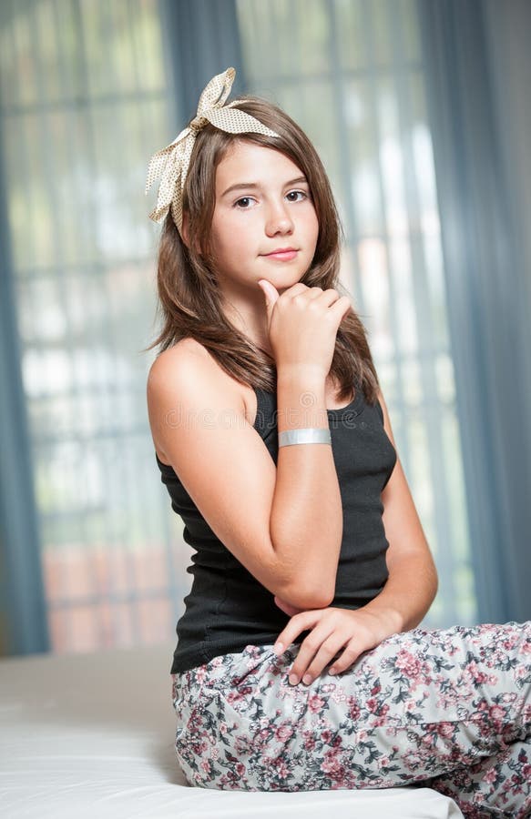 .Image of pretty teenager posing indoor in a good mood