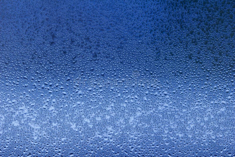 Macro abstract texture in blue color of moisture condensation on a glass window pane stock photo Macro abstract texture in blue color of moisture condensation on a glass window pane stock photo