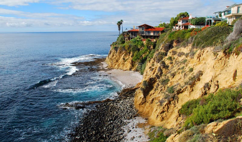 Image shows spectacular cliff side homes just north of Crescent Bay in Laguna Beach, California. View is from the public accessed Crescent Bay Point Park. Image shows spectacular cliff side homes just north of Crescent Bay in Laguna Beach, California. View is from the public accessed Crescent Bay Point Park