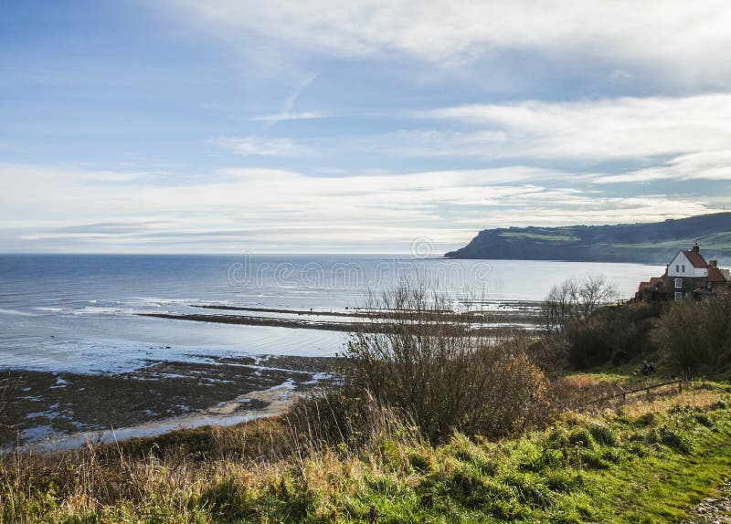 Yorkshire, England, Robin Hood`s Bay - the sea and the meadows.