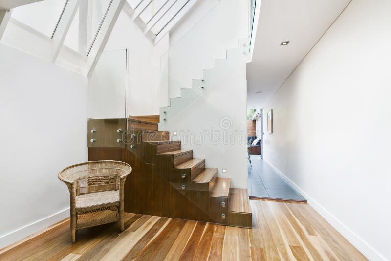 Image of solid wooden stairs with elegant glass balustrade stock image