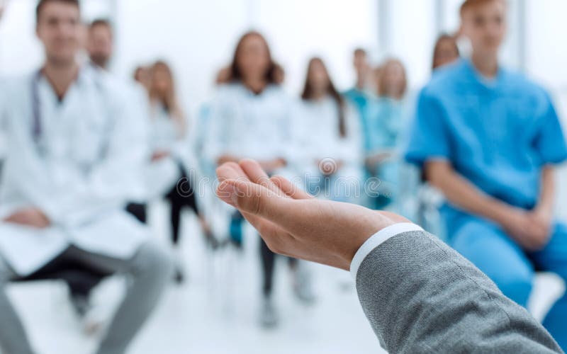 Image of a speaker and a group of doctors in a conference room royalty free stock images