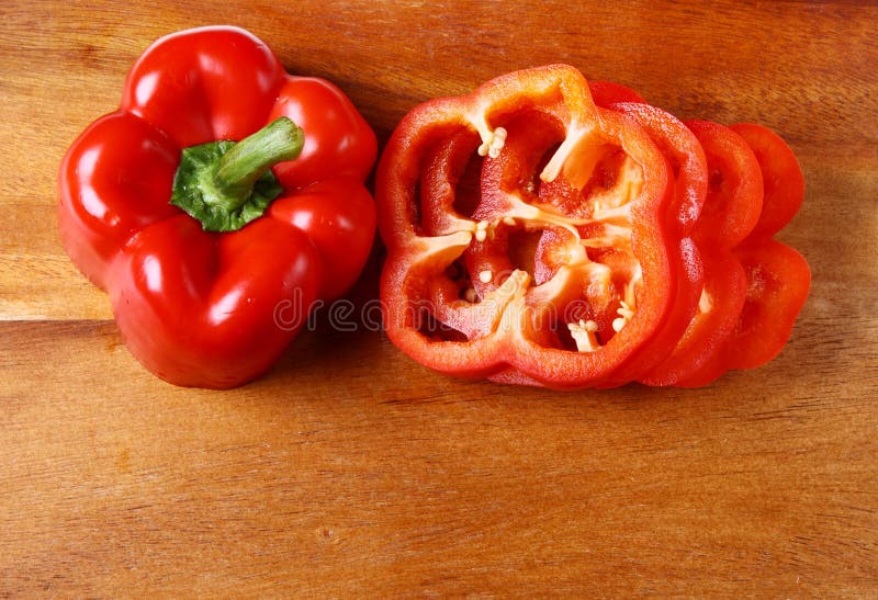 Image of sweet red pepper sliced on hardboard