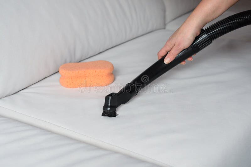 Vacuum cleaning the sofa stock image. Image of equipment 133132367