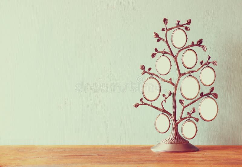Image of vintage antique classical frame of family tree on wooden table.