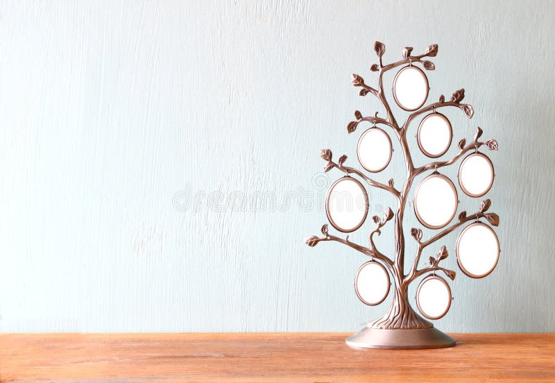 Image of vintage antique classical frame of family tree on wooden table