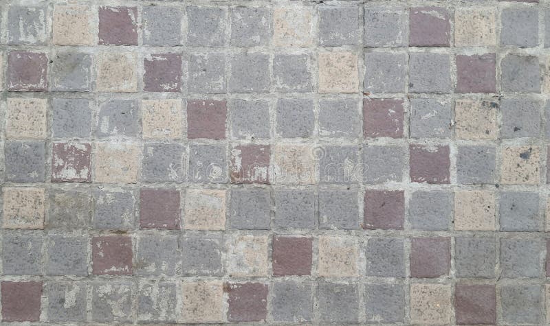 Image of a walkway made of alternating red, grey and cream stones. Stone pavement texture. stock illustration