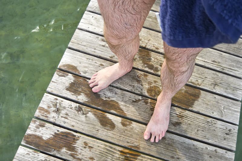 An image of wet hairy legs after swimming in the lake Starnberg