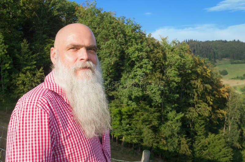 White bearded man in the forest stock photography