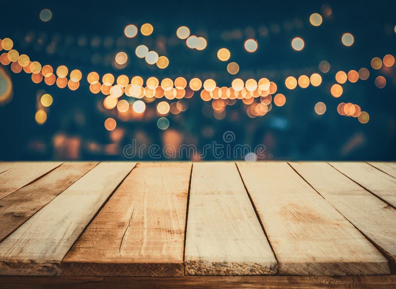 Image of wooden table in front of abstract blurred restaurant lights background royalty free stock photography