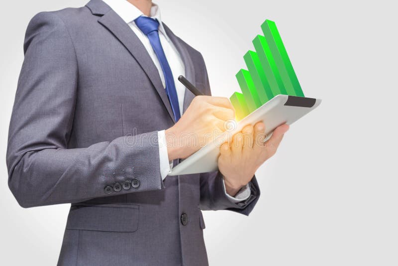 Business man using touchpad, tablet to retrieve and analyze data with green stick graph indicator on the top of tablet PC royalty free stock photo