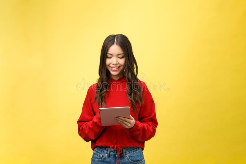 Imagem do adolescente feliz com o isolado do computador do PC da tabuleta no fundo amarelo foto de stock Imagem do adolescente feliz com o isolado do computador do PC da tabuleta no fundo amarelo foto de stock