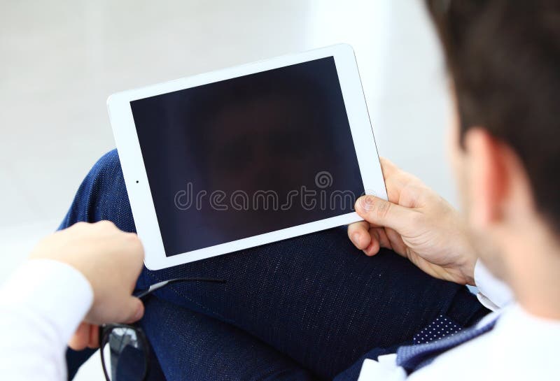 Close-up image of an office worker using a touchpad to analyze statistical data. Close-up image of an office worker using a touchpad to analyze statistical data