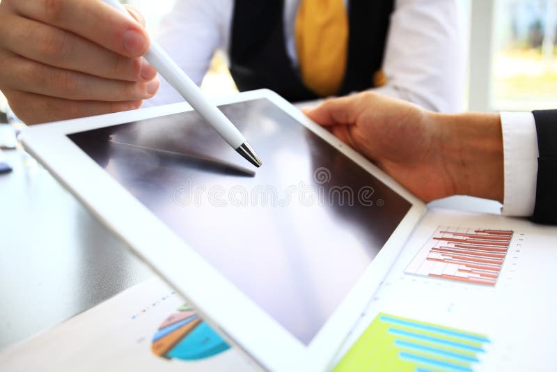 Close-up image of an office worker using a touchpad to analyze statistical data. Close-up image of an office worker using a touchpad to analyze statistical data