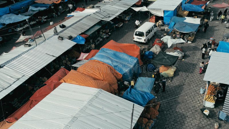imagen aérea del abejón del mercado de la ciudad de la mañana con las tiendas coloridas que miran abajo del primer mientras que g imagen de archivo imagen aérea del abejón del mercado de la ciudad de la mañana con las tiendas coloridas que miran abajo del primer mientras que g imagen de archivo