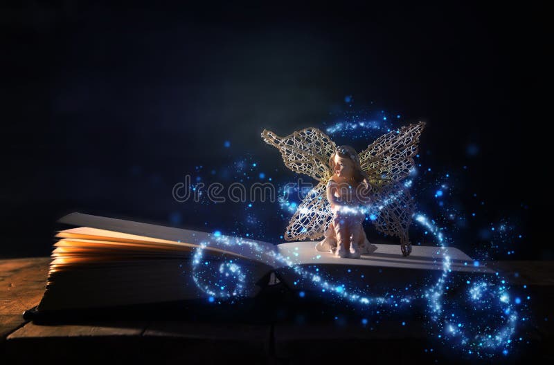 image of magical little fairy sitting on old story book. image of magical little fairy sitting on old story book