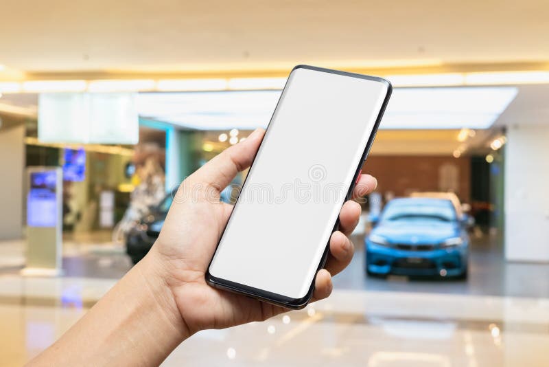 Imagen de una camioneta sosteniendo un teléfono móvil inteligente de pantalla en blanco con fondo borroso de los nuevos autos mos fotos de archivo Imagen de una camioneta sosteniendo un teléfono móvil inteligente de pantalla en blanco con fondo borroso de los nuevos autos mos fotos de archivo