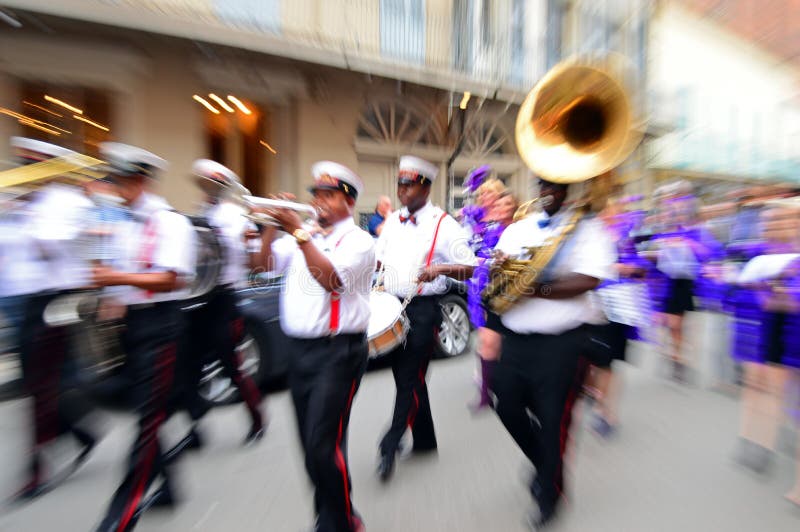 A zoom shot of a second line marching through the French Quarter of New Orleans. A zoom shot of a second line marching through the French Quarter of New Orleans