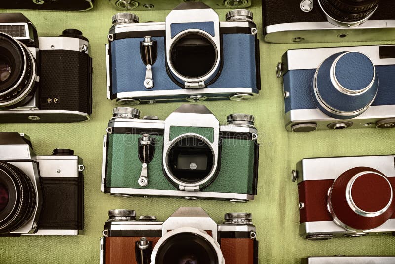 Retro styled image of colorful photo cameras on a flee market. Retro styled image of colorful photo cameras on a flee market