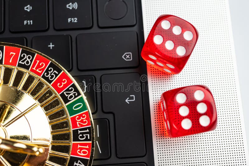Imagen que muestra una escena de juegos de azar en línea con un portátil que muestra una interfaz de juego de casino que sugiere u fotos de archivo