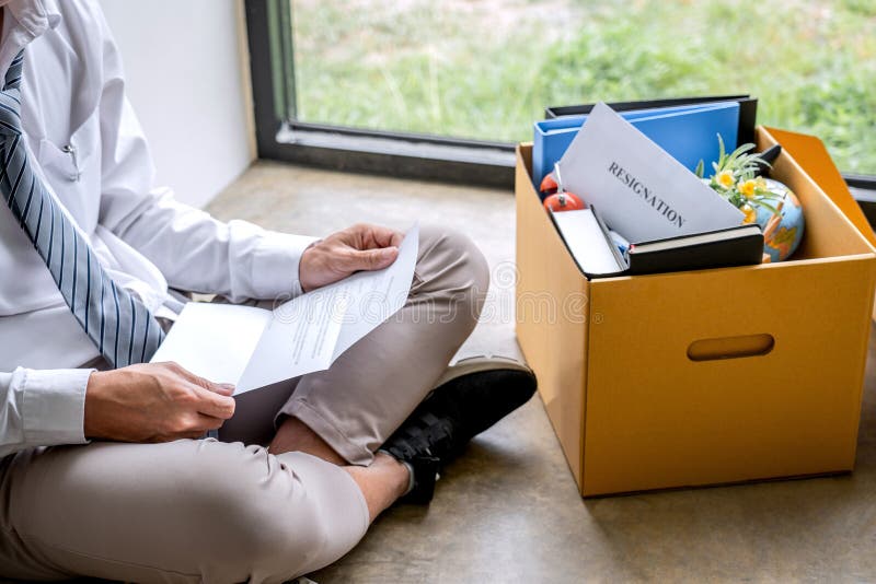 Images of businessman carrying packing up all his personal belongings and files into a brown cardboard box has frustrated and stock photography Images of businessman carrying packing up all his personal belongings and files into a brown cardboard box has frustrated and stock photography