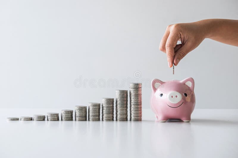 Images of stacking coins pile and Hand putting coin into pink piggy bank for planning step up to growing and savings with money royalty free stock photography Images of stacking coins pile and Hand putting coin into pink piggy bank for planning step up to growing and savings with money royalty free stock photography