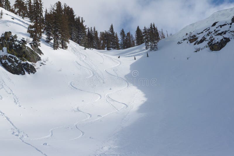 Mountain Bowl with Ski Tracks and Roller Balls � Signs of Wet Snow Instability on Sunny Slope royalty free stock photo
