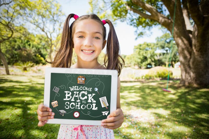 back to school against portrait of young girl holding digital tablet. back to school against portrait of young girl holding digital tablet