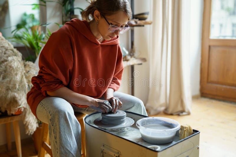 Immersive in Process Woman Sculptor Using Potter Wheel Sits at Ceramic