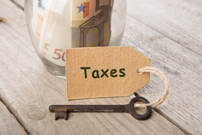Immobilienfinanzkonzept - Geldglas mit Steuerwort lizenzfreies stockfoto Immobilienfinanzkonzept - Geldglas mit Steuerwort lizenzfreies stockfoto