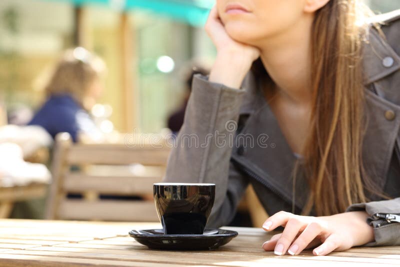 Impatient woman waiting on a cafe terrace