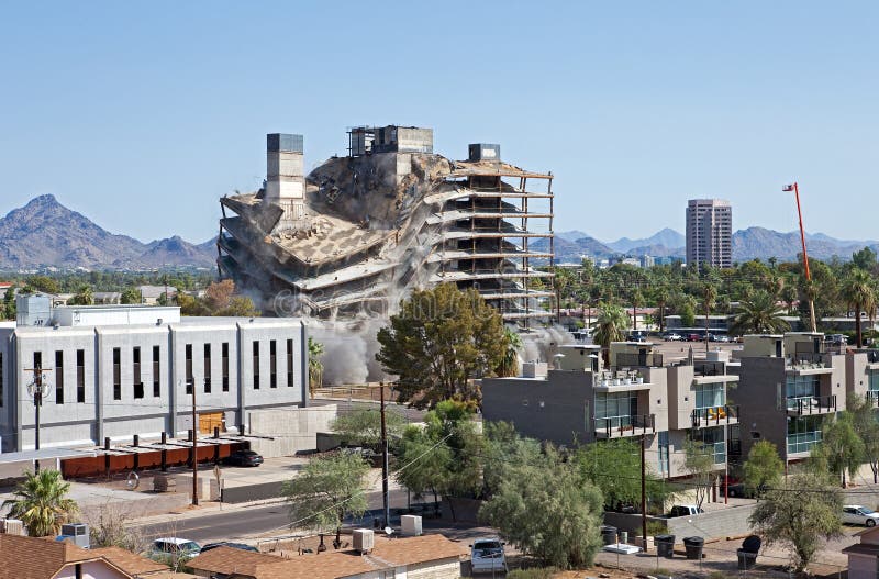 Building implodes, after series of explosions. Building implodes, after series of explosions.