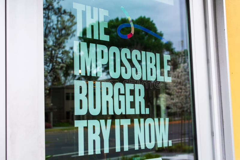 Impossible Burger poster advertises meatless plant-based substitute food at fast food restaurant. The vegan burger supplied by stock image